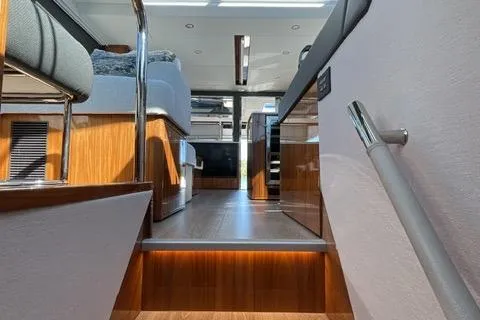 Yacht Photos Pics Interior view of 2025 Riviera 585 SUV yacht, featuring modern design and wood accents.