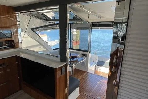  Yacht Photos Pics Interior view of 2025 Riviera 585 SUV yacht, featuring modern design and waterfront backdrop.