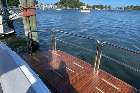  Yacht Photos Pics Luxury 2025 Riviera 585 SUV yacht deck with scenic waterfront view.