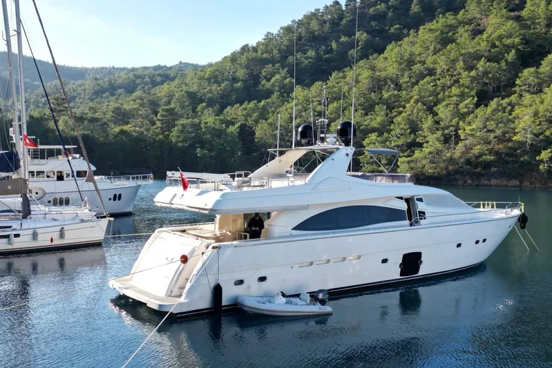  Yacht Photos Pics 2008 Ferretti Yachts 830 moored in scenic bay with lush green hills.