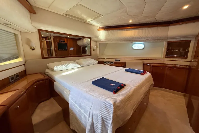  Yacht Photos Pics Luxurious bedroom interior of 2008 Ferretti Yachts 830 with elegant wood finishes.