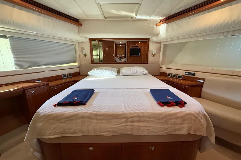  Yacht Photos Pics Luxurious bedroom interior of 2008 Ferretti Yachts 830 with elegant wood finishes.