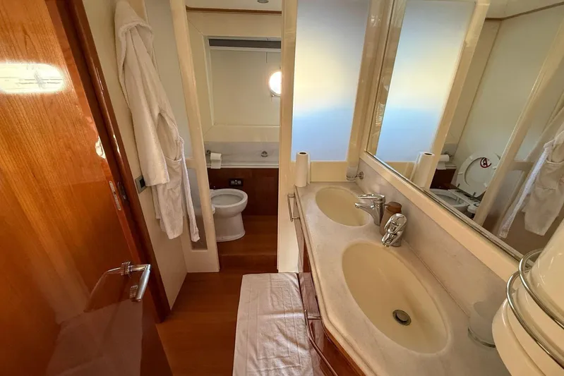  Yacht Photos Pics Luxurious bathroom in 2008 Ferretti Yachts 830, featuring dual sinks and elegant wood finishes.