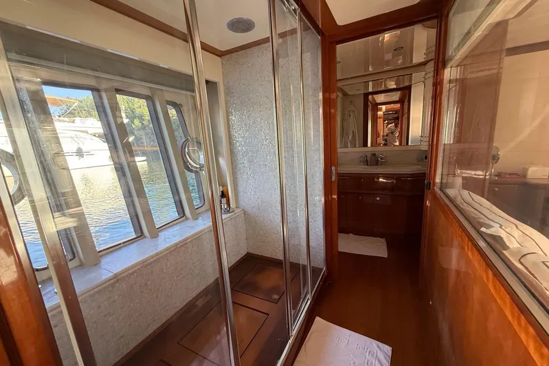  Yacht Photos Pics Luxurious bathroom interior of 2008 Ferretti Yachts 830 with elegant wood finishes and large windows.