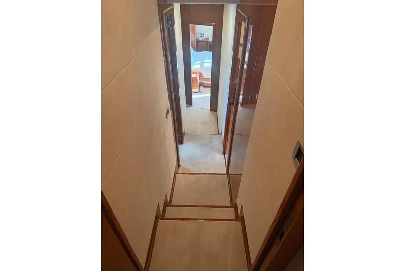  Yacht Photos Pics Narrow hallway inside 2008 Ferretti Yachts 830, featuring wooden doors and carpeted flooring.