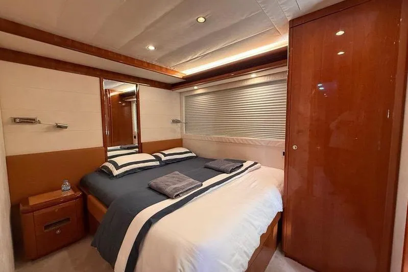  Yacht Photos Pics Luxurious bedroom interior of 2008 Ferretti Yachts 830 with elegant wood finishes.