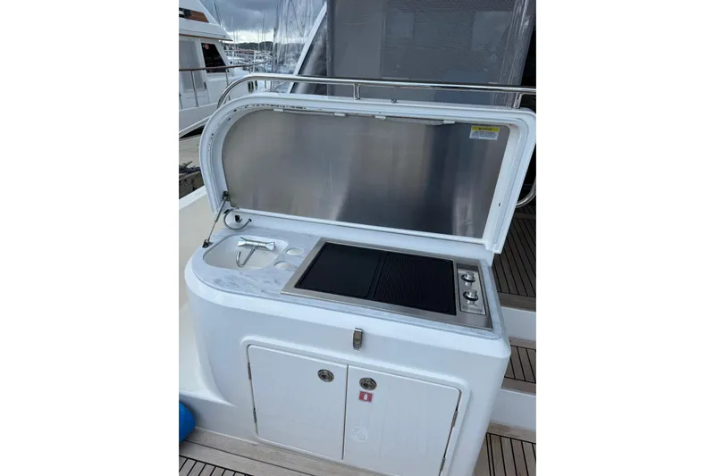  Yacht Photos Pics Outdoor kitchen on 2025 Riviera 50 Sports Motor Yacht with grill and sink.