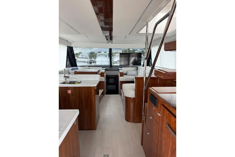  Yacht Photos Pics Interior of 2025 Riviera 50 Sports Motor Yacht with modern wood finishes and spacious layout.