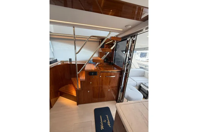  Yacht Photos Pics Luxurious interior of 2025 Riviera 50 Sports Motor Yacht with polished wood and modern design.