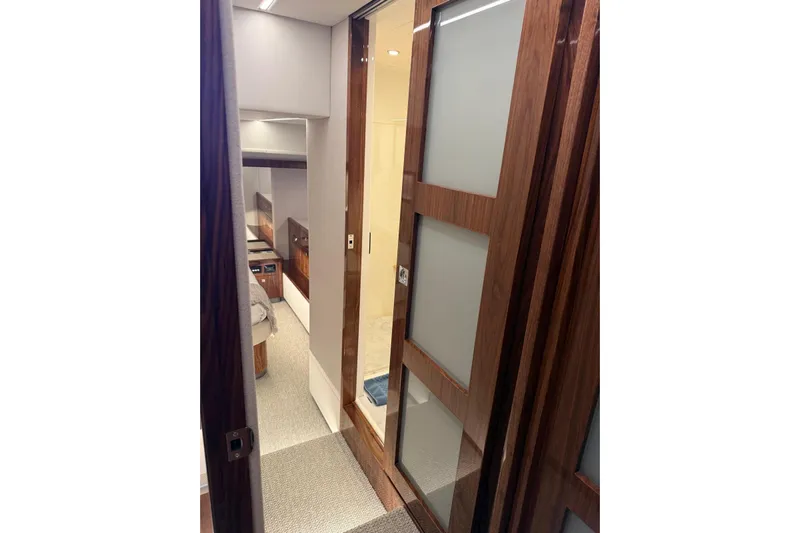 Yacht Photos Pics Interior hallway of 2025 Riviera 50 Sports Motor Yacht with modern wood paneling.