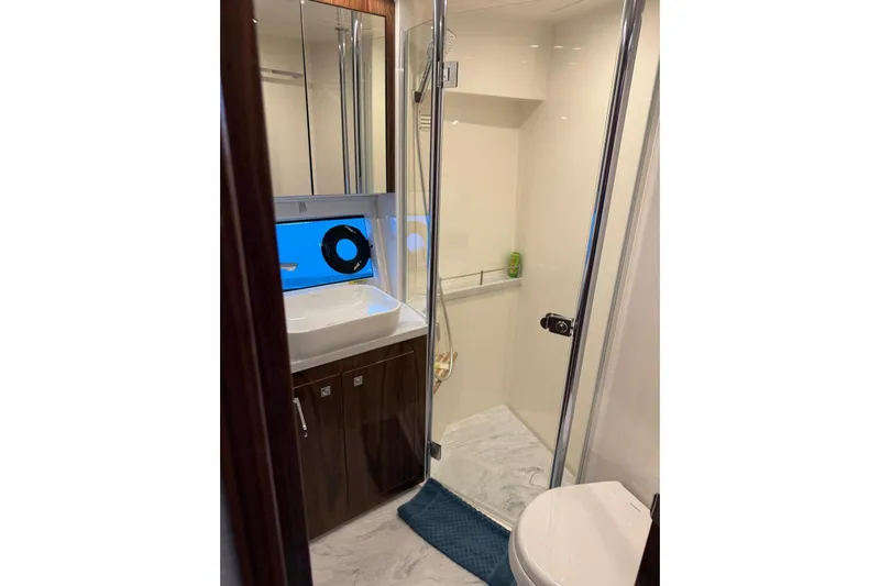  Yacht Photos Pics Luxurious bathroom in 2025 Riviera 50 Sports Motor Yacht with modern fixtures and elegant design.