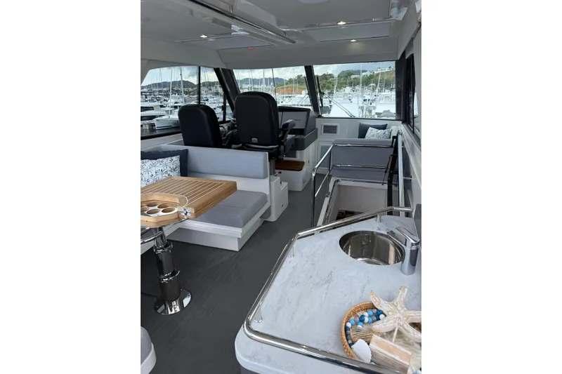  Yacht Photos Pics Interior of 2025 Riviera 50 Sports Motor Yacht with modern seating and helm.