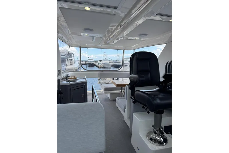  Yacht Photos Pics Interior of 2025 Riviera 50 Sports Motor Yacht with luxurious seating and marina view.