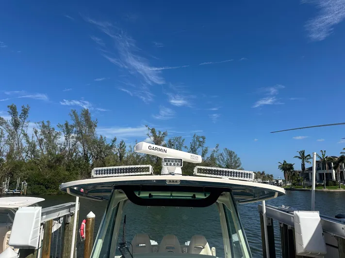  Yacht Photos Pics 2021 Grady-White 336 Canyon boat docked under clear blue sky.
