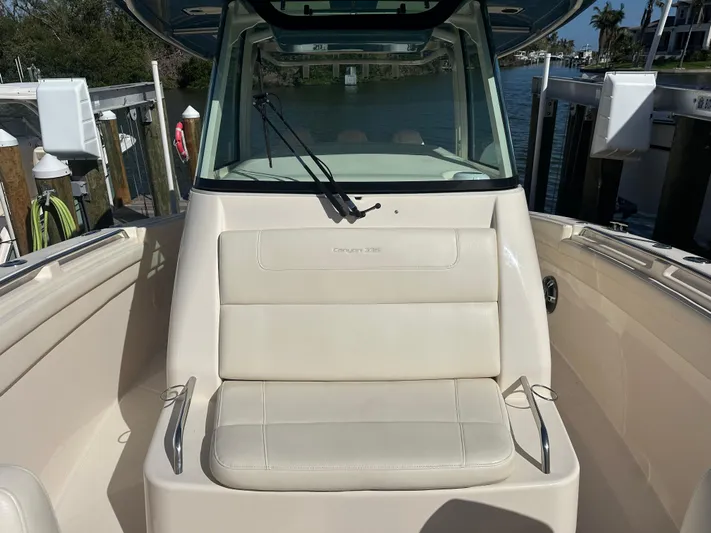  Yacht Photos Pics 2021 Grady-White 336 Canyon boat interior with cushioned seating and windshield.