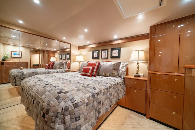 Mariah Jean Yacht Photos Pics Luxurious bedroom interior on a 2004 Viking 61c yacht, featuring elegant decor and ambient lighting.