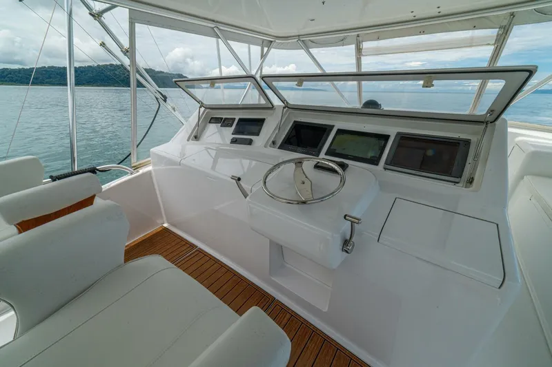 Mariah Jean Yacht Photos Pics Helm of 2004 Viking 61c yacht with modern navigation equipment and ocean view.