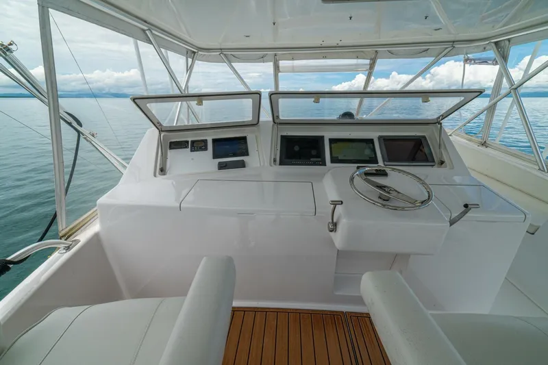 Mariah Jean Yacht Photos Pics Helm of 2004 Viking 61c yacht with modern navigation equipment and ocean view.