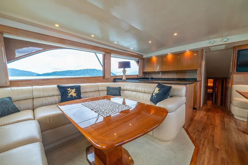 Mariah Jean Yacht Photos Pics Luxurious interior of a 2004 Viking 61c yacht with elegant seating and wooden finishes.