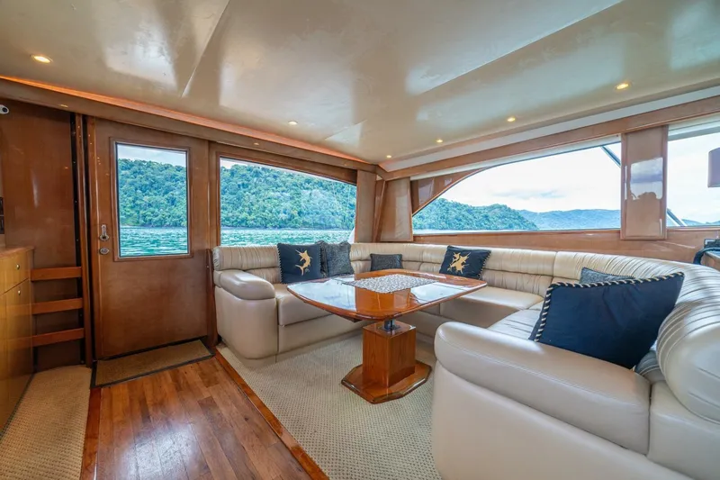 Mariah Jean Yacht Photos Pics Luxurious interior of 2004 Viking 61c yacht with plush seating and scenic window views.