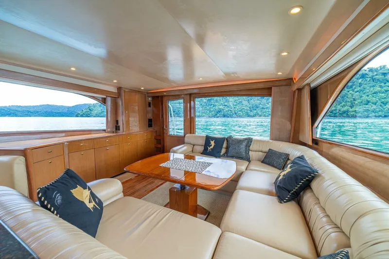 Mariah Jean Yacht Photos Pics Luxurious interior of 2004 Viking 61c yacht with plush seating and scenic water views.