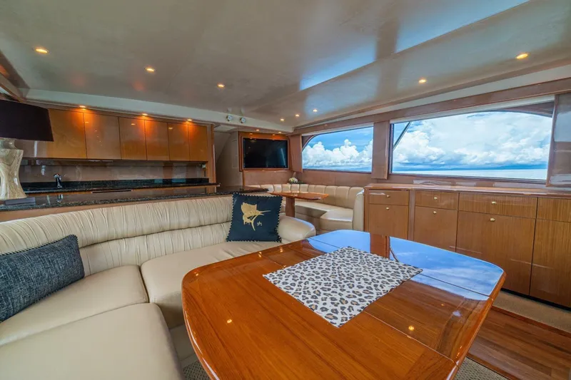 Mariah Jean Yacht Photos Pics Luxurious interior of 2004 Viking 61c yacht with elegant seating and panoramic windows.