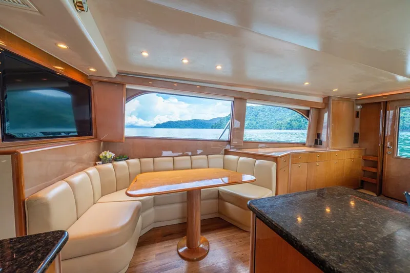 Mariah Jean Yacht Photos Pics Luxurious interior of 2004 Viking 61c yacht with elegant seating and scenic ocean view.