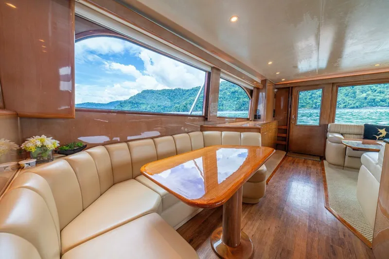 Mariah Jean Yacht Photos Pics Luxurious interior of 2004 Viking 61c yacht with elegant seating and scenic window views.