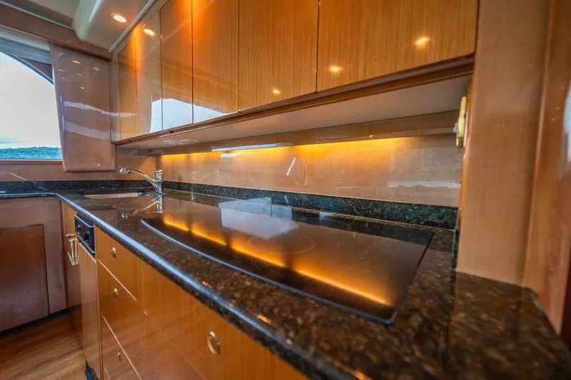 Mariah Jean Yacht Photos Pics Luxurious kitchen interior of 2004 Viking 61c yacht with sleek wood cabinetry and modern appliances.