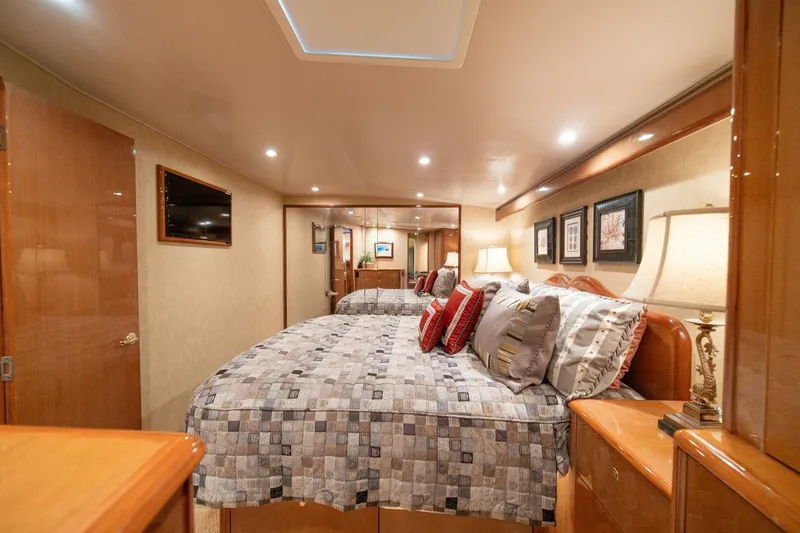 Mariah Jean Yacht Photos Pics Luxurious bedroom interior of 2004 Viking 61c yacht with elegant decor and ambient lighting.