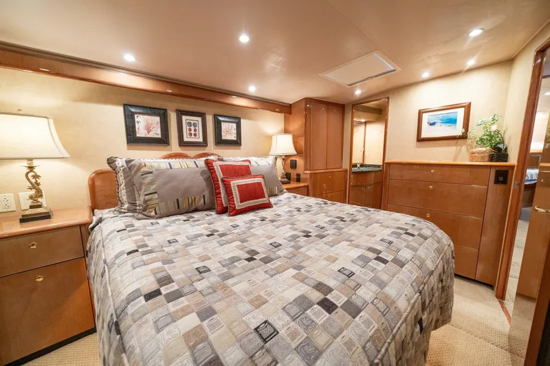 Mariah Jean Yacht Photos Pics Luxurious bedroom interior of 2004 Viking 61c yacht with elegant decor and cozy bedding.
