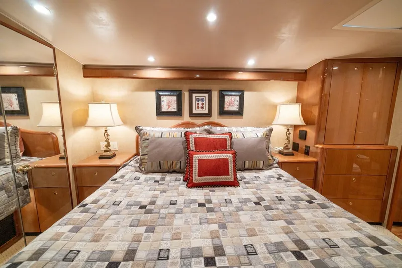 Mariah Jean Yacht Photos Pics Luxurious bedroom interior of 2004 Viking 61 Convertible yacht with elegant decor and lighting.