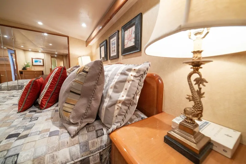 Mariah Jean Yacht Photos Pics Luxurious bedroom interior of 2004 Viking 61 Convertible yacht with elegant decor and plush pillows.