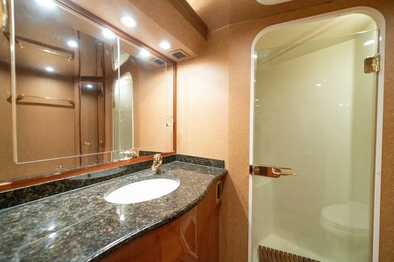 Mariah Jean Yacht Photos Pics Luxurious bathroom in 2004 Viking 61 Convertible yacht with granite countertop and glass shower.
