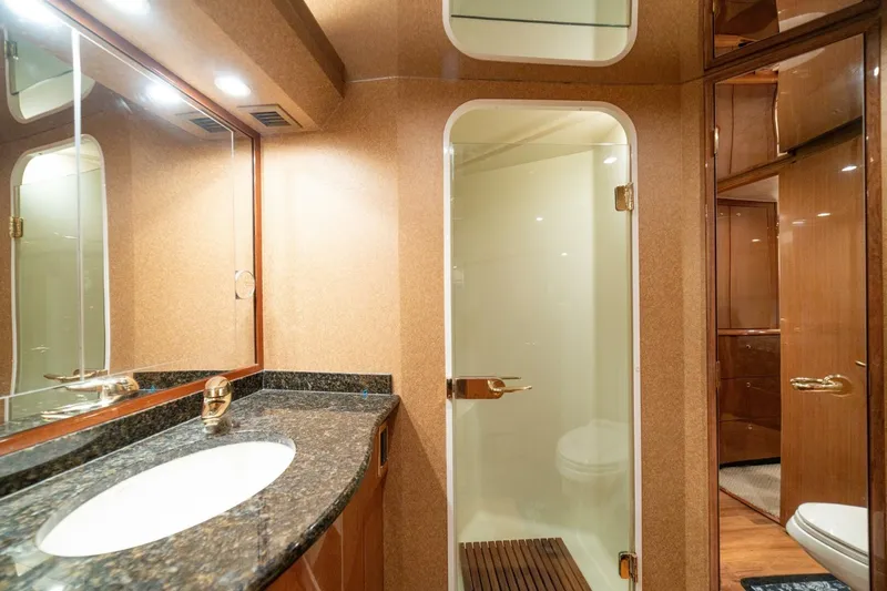 Mariah Jean Yacht Photos Pics Luxurious bathroom in 2004 Viking 61 Convertible yacht with granite countertop and glass shower.