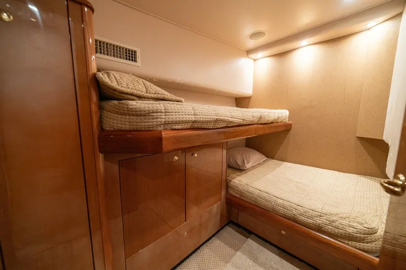 Mariah Jean Yacht Photos Pics Interior of 2004 Viking 61 Convertible yacht with cozy bunk beds and wooden cabinetry.