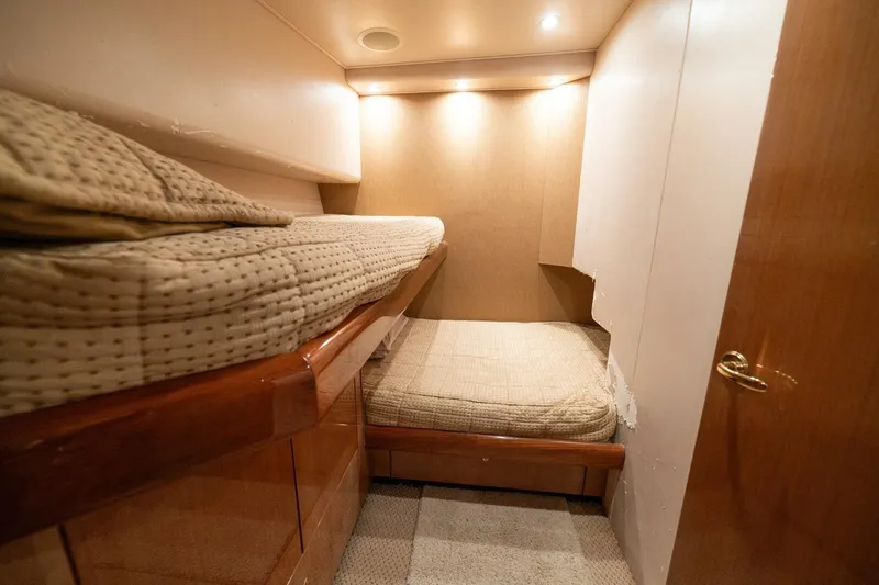 Mariah Jean Yacht Photos Pics 2004 Viking 61 Convertible yacht cabin with cozy bunk beds and warm lighting.