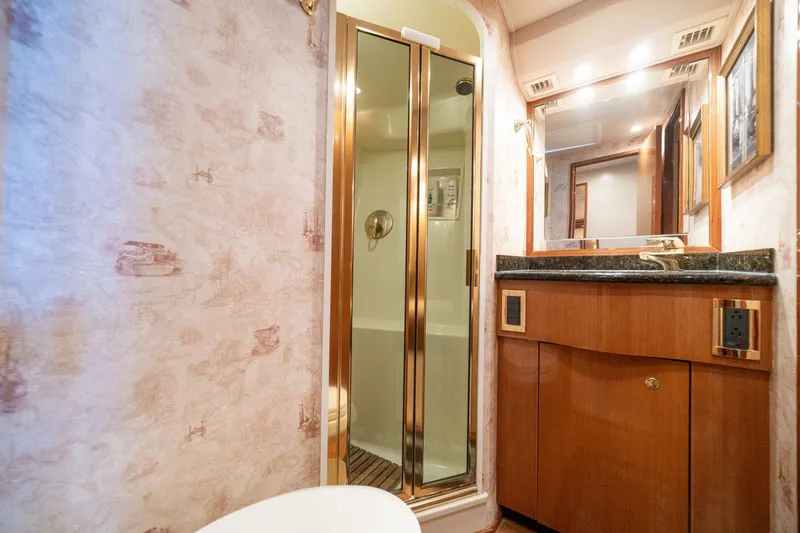 Mariah Jean Yacht Photos Pics Luxurious bathroom in 2004 Viking 61c yacht with shower and wooden cabinetry.