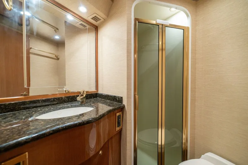 Mariah Jean Yacht Photos Pics Luxurious bathroom in 2004 Viking 61c yacht with granite countertop and glass shower.