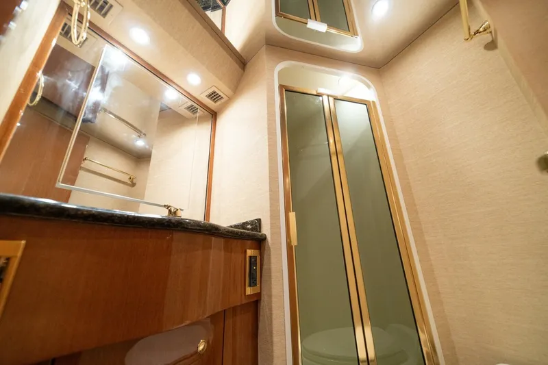 Mariah Jean Yacht Photos Pics Luxurious bathroom interior of 2004 Viking 61c yacht with elegant fixtures and lighting.