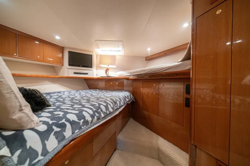 Mariah Jean Yacht Photos Pics Luxurious 2004 Viking 61c yacht cabin with cozy beds and elegant wood finishes.