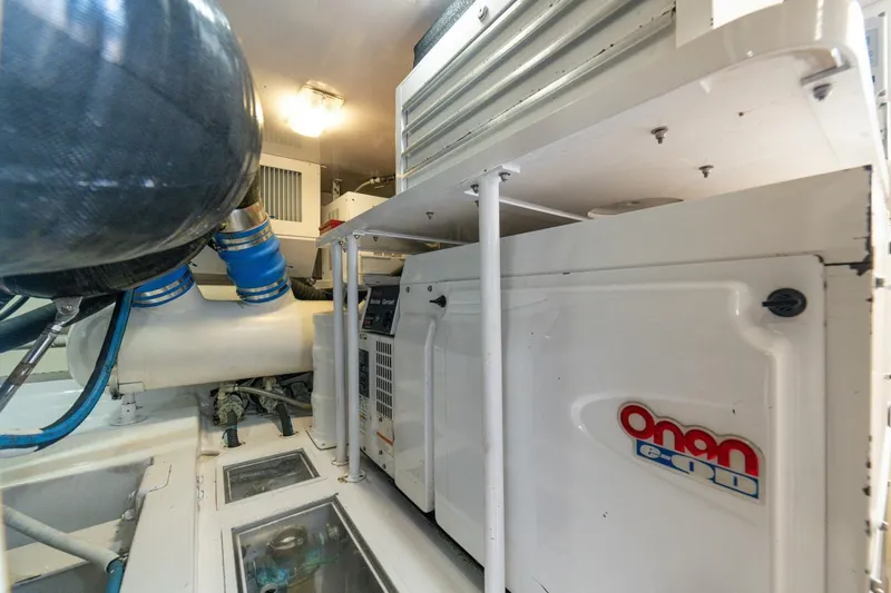 Mariah Jean Yacht Photos Pics Engine room of 2004 Viking 61c yacht featuring Onan generator and mechanical components.