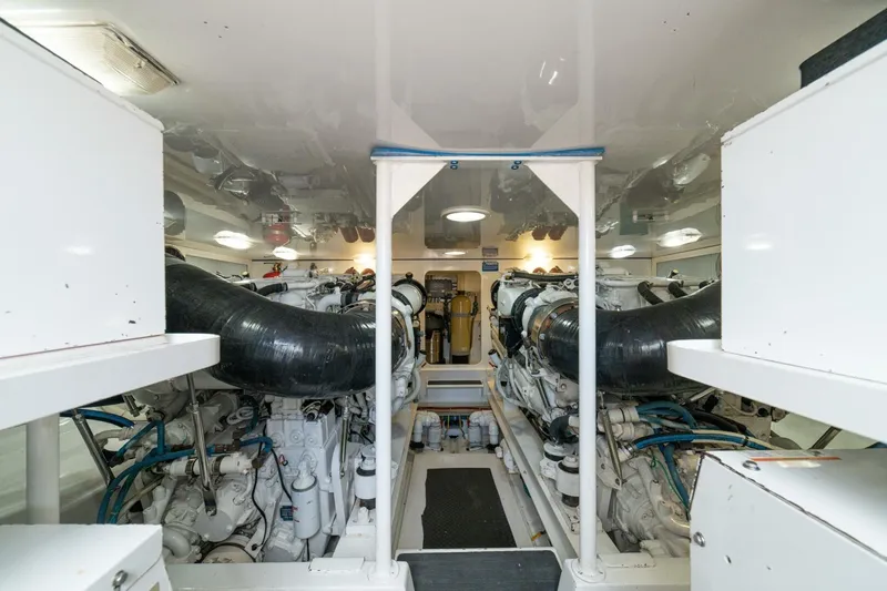 Mariah Jean Yacht Photos Pics Engine room of a 2004 Viking 61c yacht, featuring dual engines and clean layout.