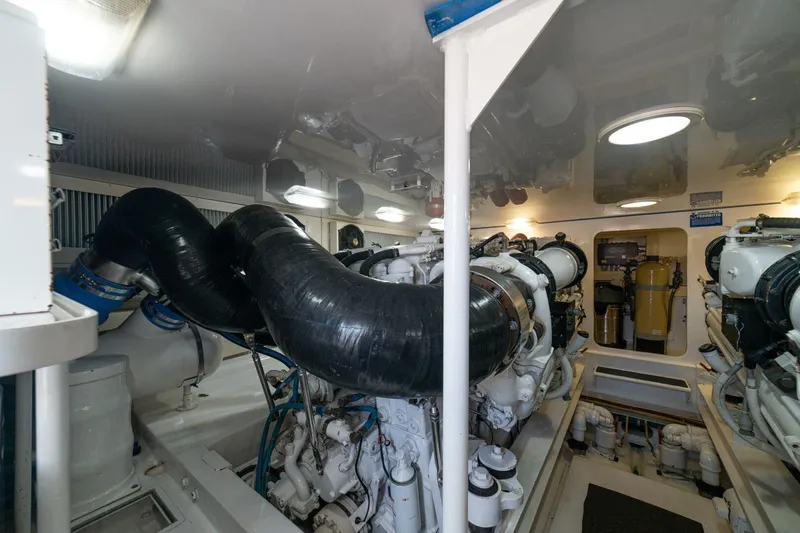 Mariah Jean Yacht Photos Pics Engine room of a 2004 Viking 61c yacht, featuring complex machinery and piping.