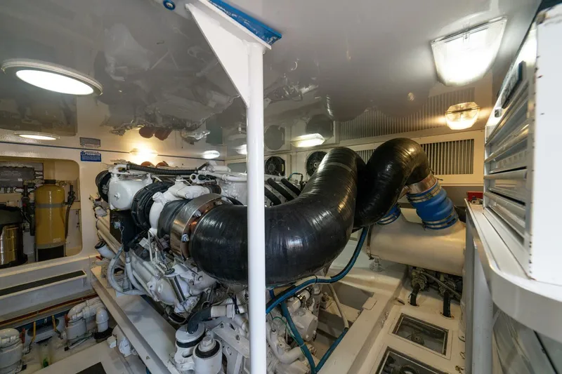 Mariah Jean Yacht Photos Pics Engine room of a 2004 Viking 61c yacht, featuring complex machinery and piping.
