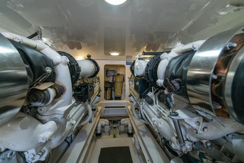 Mariah Jean Yacht Photos Pics Engine room of a 2004 Viking 61c yacht, showcasing dual engines and mechanical components.