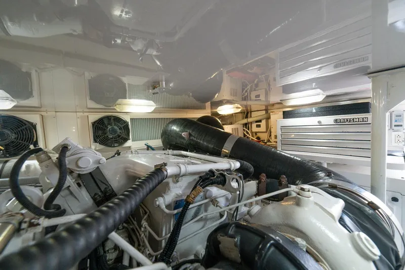 Mariah Jean Yacht Photos Pics Engine room of a 2004 Viking 61c yacht with visible machinery and tool storage.