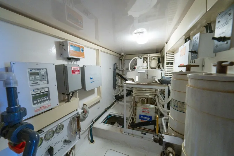 Mariah Jean Yacht Photos Pics Engine room of a 2004 Viking 61c yacht, featuring control panels and machinery.