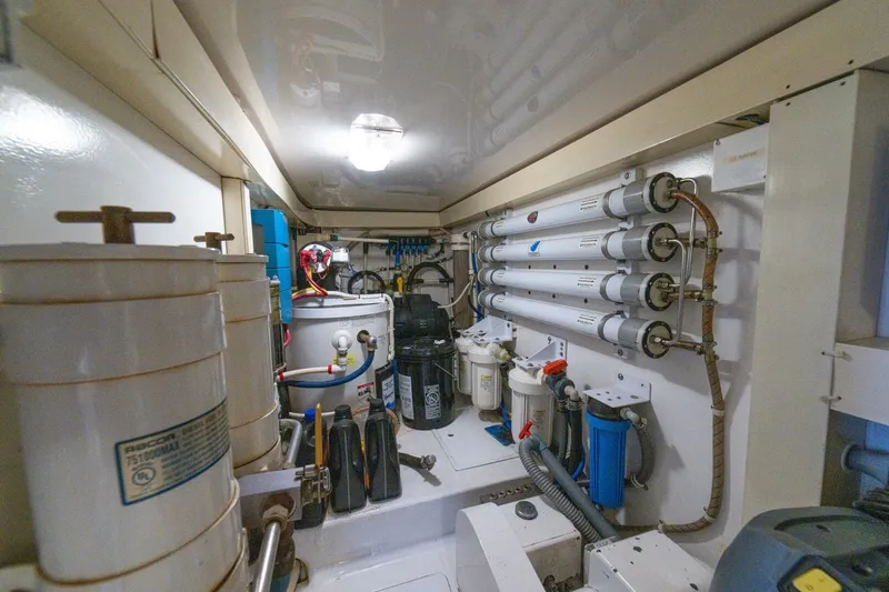 Mariah Jean Yacht Photos Pics Engine room of a 2004 Viking 61c yacht, featuring filtration systems and mechanical equipment.