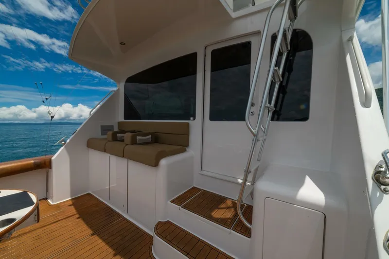 Mariah Jean Yacht Photos Pics 2004 Viking 61c yacht deck with seating, ladder, and ocean view.